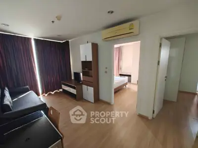 Modern apartment living room with wooden flooring and air conditioning