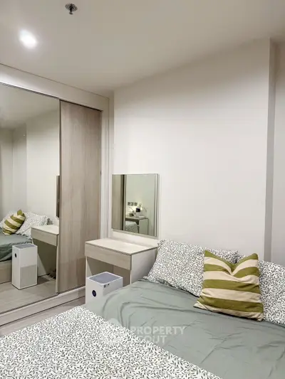 Cozy bedroom with modern decor and mirrored wardrobe