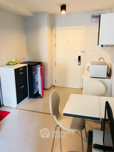 Modern compact kitchen with dining area in stylish apartment