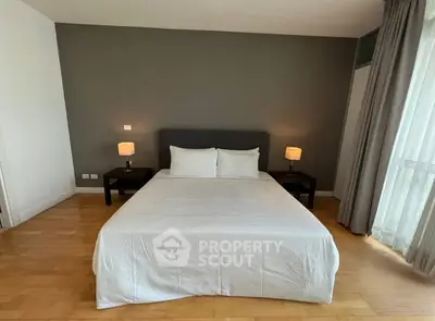 Spacious bedroom with modern decor and ample natural light