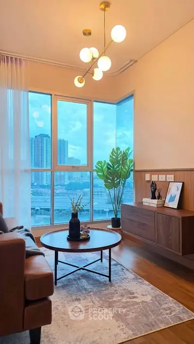 Modern living room with large windows offering stunning city views, stylish furniture, and elegant lighting.