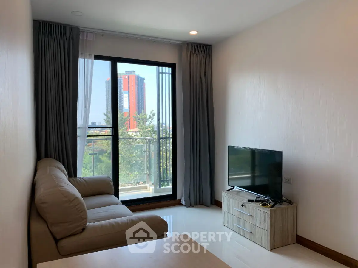 Modern living room with balcony view and sleek furniture in urban apartment
