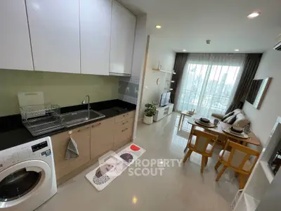 Modern open-plan kitchen and living room with sleek design and city view balcony.