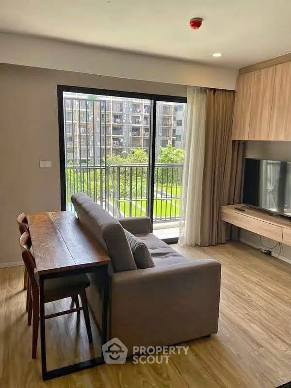 Modern living room with large window and balcony view in stylish apartment