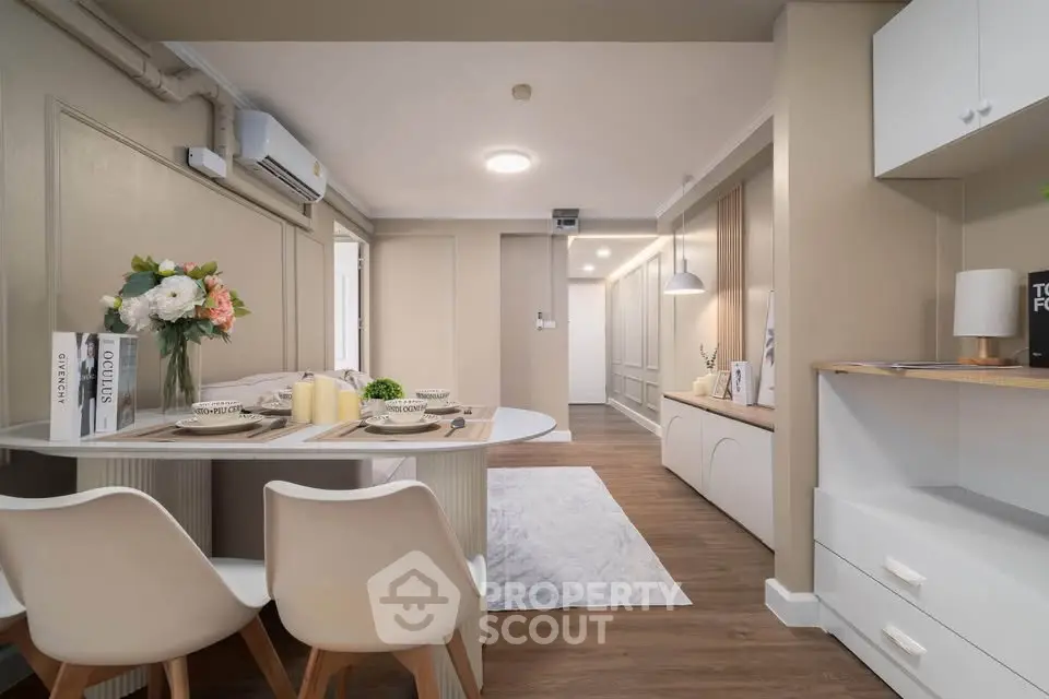 Modern dining area with elegant decor and cozy ambiance in a stylish apartment.