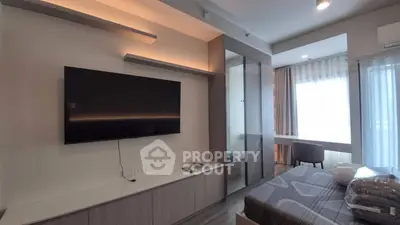 Modern bedroom with wall-mounted TV and large window for natural light