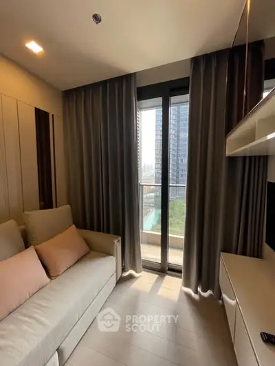 Modern living room with floor-to-ceiling windows and city view, featuring a cozy sofa and elegant curtains.