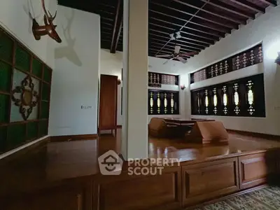 Elegant living room with traditional wooden decor and unique architectural details.