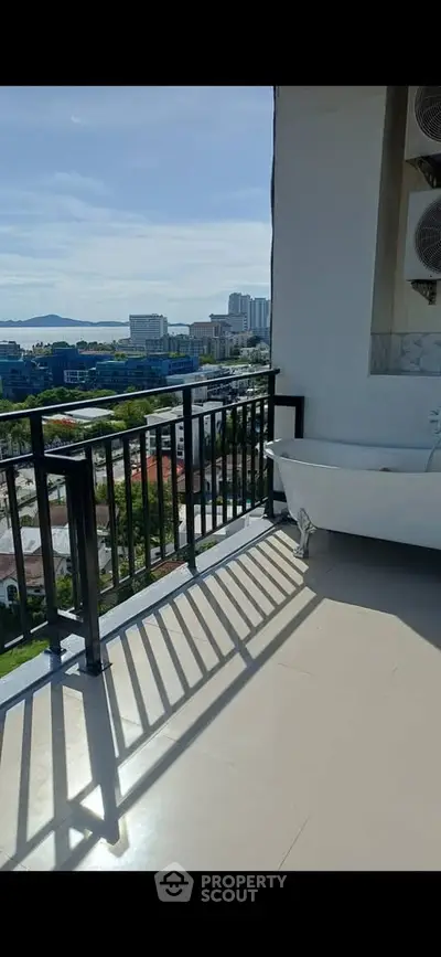 Stunning balcony with bathtub offering panoramic city views, perfect for relaxation and luxury living.