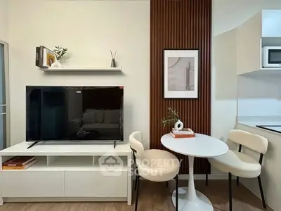 Modern living room with sleek TV setup and cozy dining area