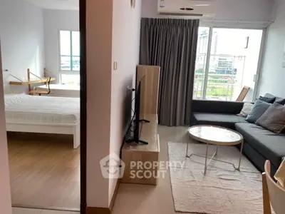 Modern apartment with cozy living room and bedroom, featuring city view and stylish decor.