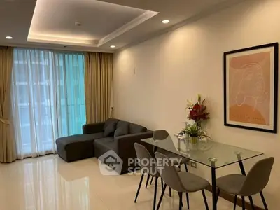 Modern living room with glass dining table and cozy sofa, perfect for urban living.