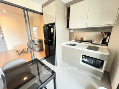 Modern kitchen with sleek appliances and open layout in stylish apartment