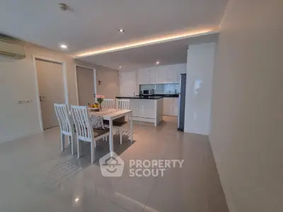 Modern dining area with sleek kitchen in open layout apartment