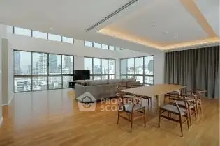 Spacious modern living room with panoramic city views and elegant wooden flooring.