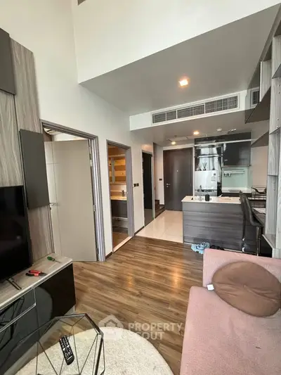 Modern living room with open kitchen and stylish decor in a contemporary apartment.