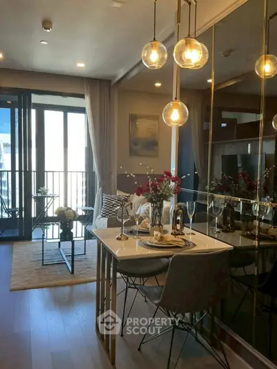 Stylish modern living room with elegant dining area and balcony view, featuring chic lighting and decor.