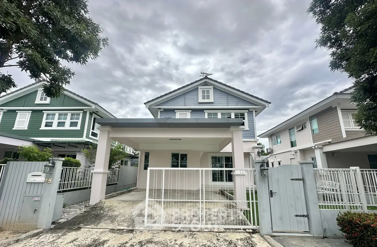 Charming two-story house with modern design and spacious driveway in a serene neighborhood.