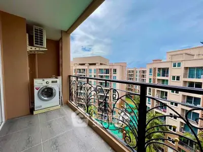 Spacious balcony with washing machine and stunning view of modern apartment complex.