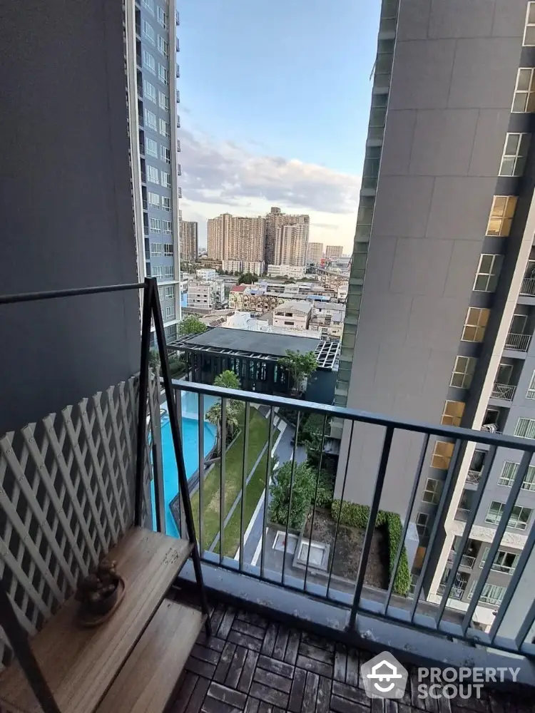 Stunning high-rise balcony view with pool and cityscape, perfect for urban living.