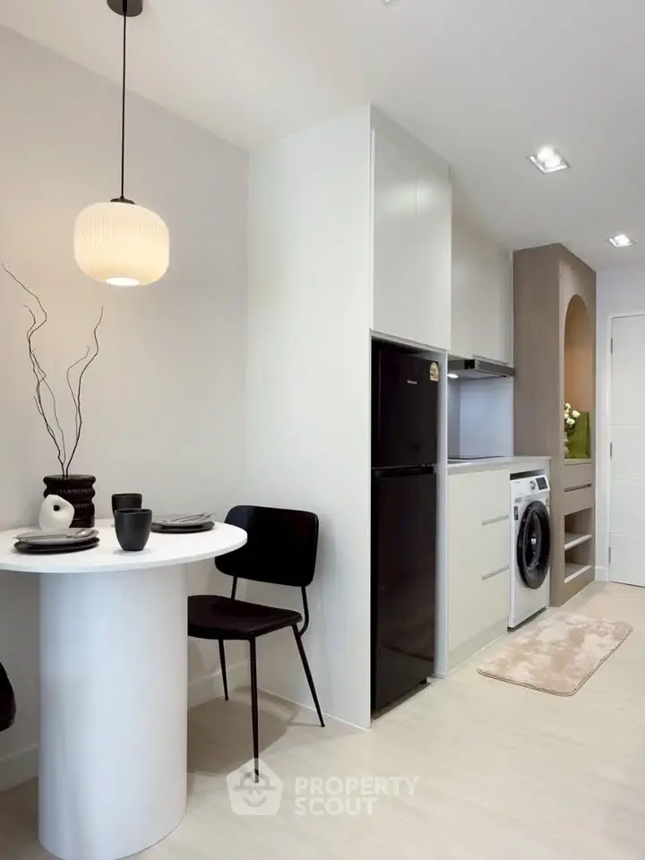Modern kitchen with sleek appliances and cozy dining area