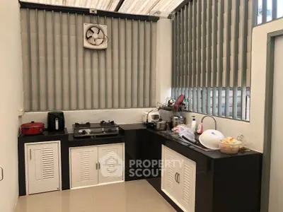 Modern kitchen with gas stove and sleek cabinetry in a bright, airy space.