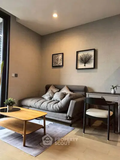 Cozy living room with modern sofa, stylish decor, and natural light.