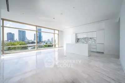 Luxurious open-plan living room with stunning city view and modern kitchen in high-rise apartment.