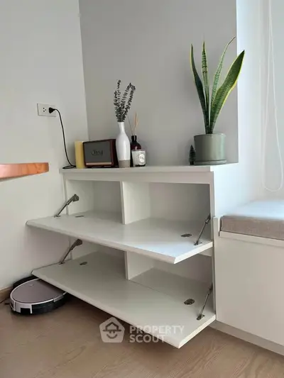 Modern minimalist living space with sleek white shelving and stylish decor