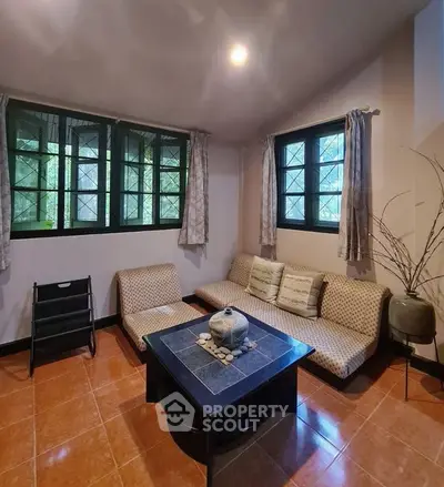 Cozy living room with modern furniture and large windows