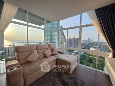 Luxurious corner unit living room with panoramic city view and plush seating.