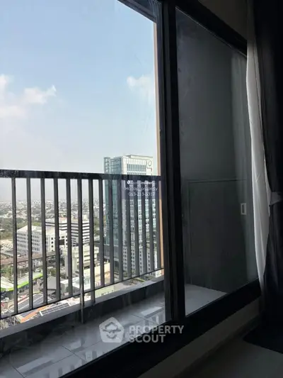Stunning high-rise apartment view with floor-to-ceiling windows overlooking cityscape.