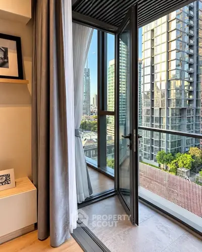 Modern apartment with open balcony offering stunning cityscape views and elegant interior design.