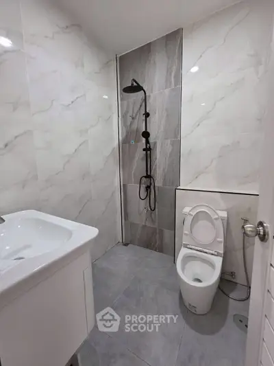 Modern bathroom with sleek shower and elegant marble tiles