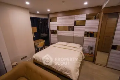 Modern bedroom with stylish decor and cozy ambiance, featuring a comfortable bed and elegant furnishings.