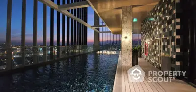 Luxurious rooftop pool with stunning city view at sunset, perfect for relaxation and leisure.