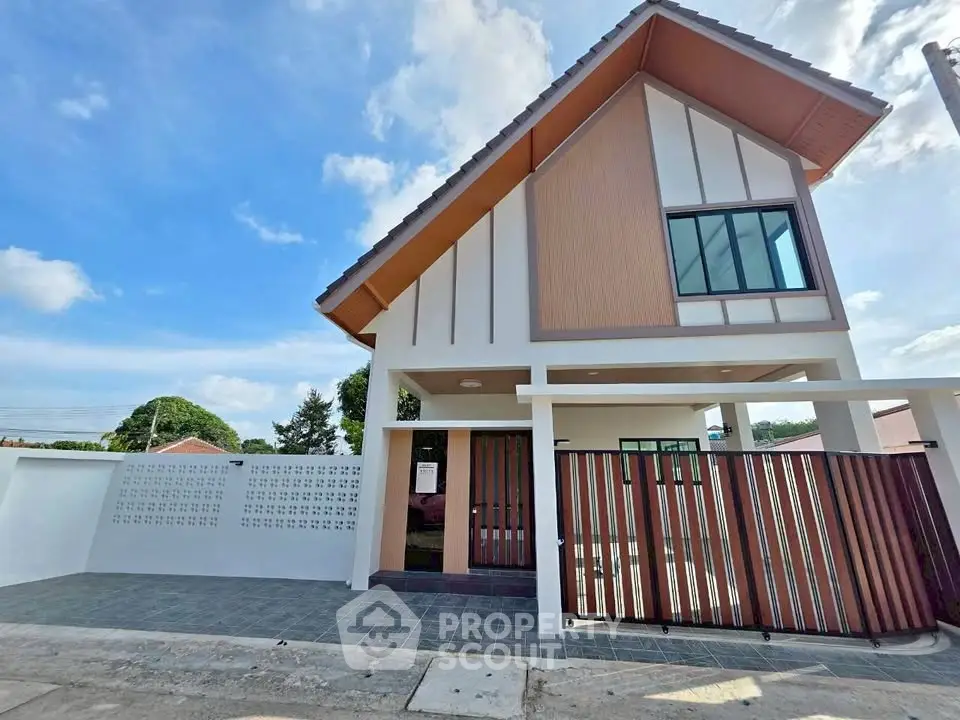 Charming modern house with sloped roof and spacious driveway in a serene neighborhood.