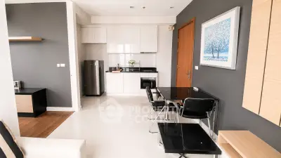Modern open-layout kitchen and dining area with sleek design and stylish furniture.