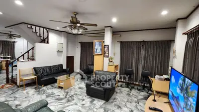 Spacious living room with leather sofas and marble flooring