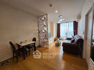 Spacious living room with elegant decor and large windows offering natural light.