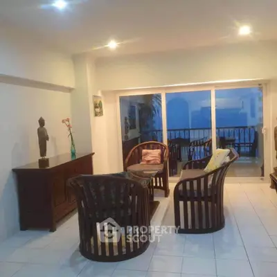 Spacious living room with elegant wooden furniture and balcony view.