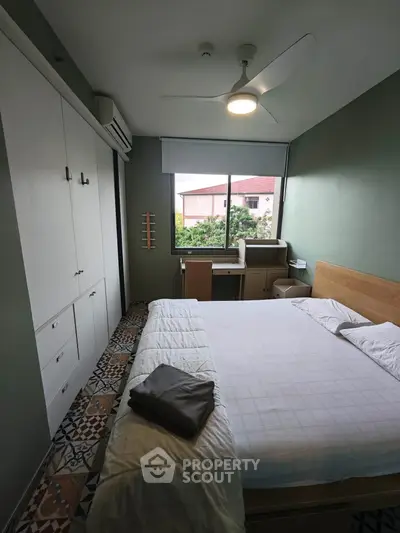 Cozy bedroom with modern decor and ample natural light