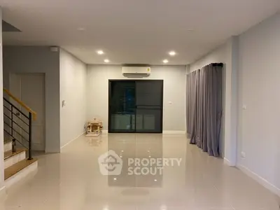 Spacious modern living room with glossy tile flooring and large window.
