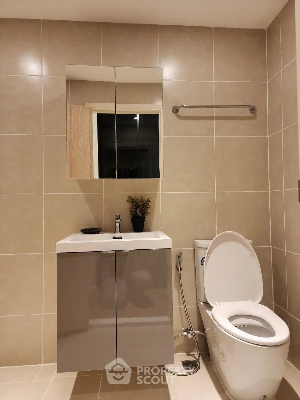 Modern bathroom with sleek fixtures and neutral tiles