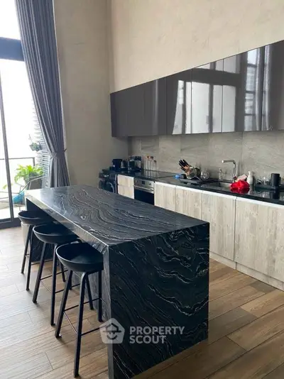 Luxurious modern kitchen with sleek island and high-end appliances, perfect for gourmet cooking.