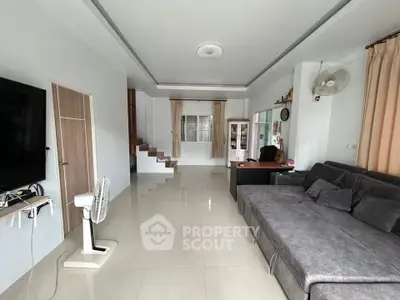 Spacious living room with modern decor and sleek furniture in a contemporary home.