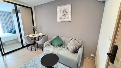 Cozy living room with modern decor and a view into the bedroom, perfect for urban living.