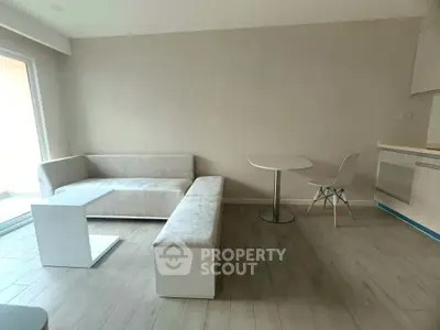 Modern minimalist living room with sleek furniture and natural light.