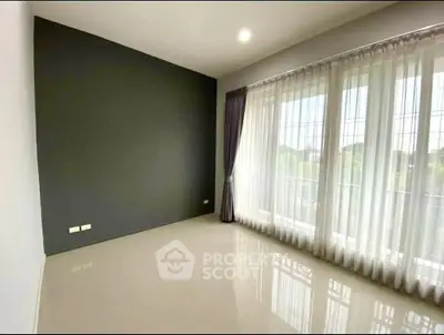 Spacious empty room with large windows and elegant curtains, perfect for customization.