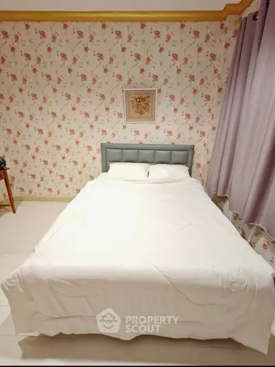 Charming bedroom with floral wallpaper and cozy bed, perfect for a restful retreat.